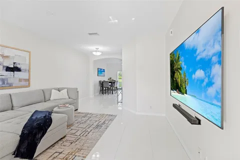a living room with furniture and a painting on the wall