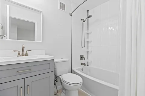 a bathroom with a sink a toilet and a mirror