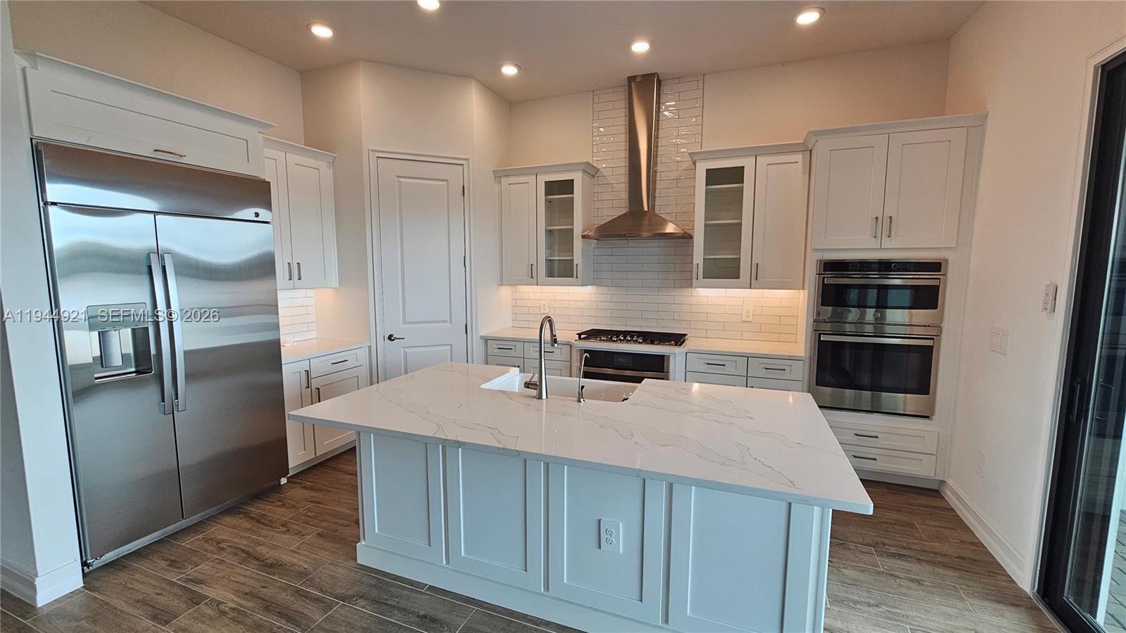 1112 Seagrape Drive Ruskin, FL 33570 - Photo 2 of 18 a kitchen with stainless steel appliances a refrigerator and a stove