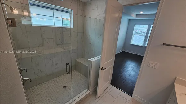 a bathroom with a sink a mirror and a shower