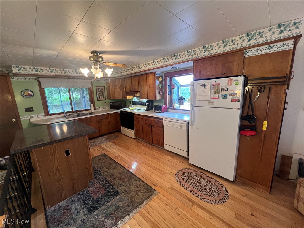 86610 Beaver Dam Road Scio, OH 43988 - Photo 15 of 50 Kitchen featuring light wood-type flooring, white appliances, kitchen peninsula, and ceiling fan
