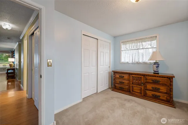 a view of room with window and wooden floor