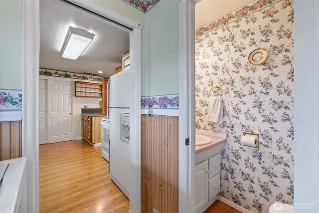 a view of a hallway with wooden floor and entryway