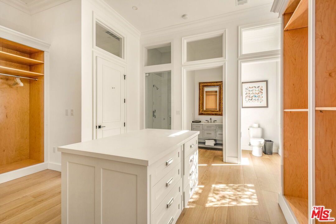 9669 Oak Pass Road Beverly Hills, CA 90210 - Photo 22 of 37 a hall with kitchen island hardwood floor and a sink