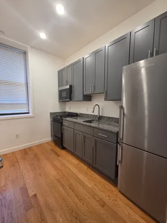 a kitchen with stainless steel appliances granite countertop a refrigerator sink and cabinets