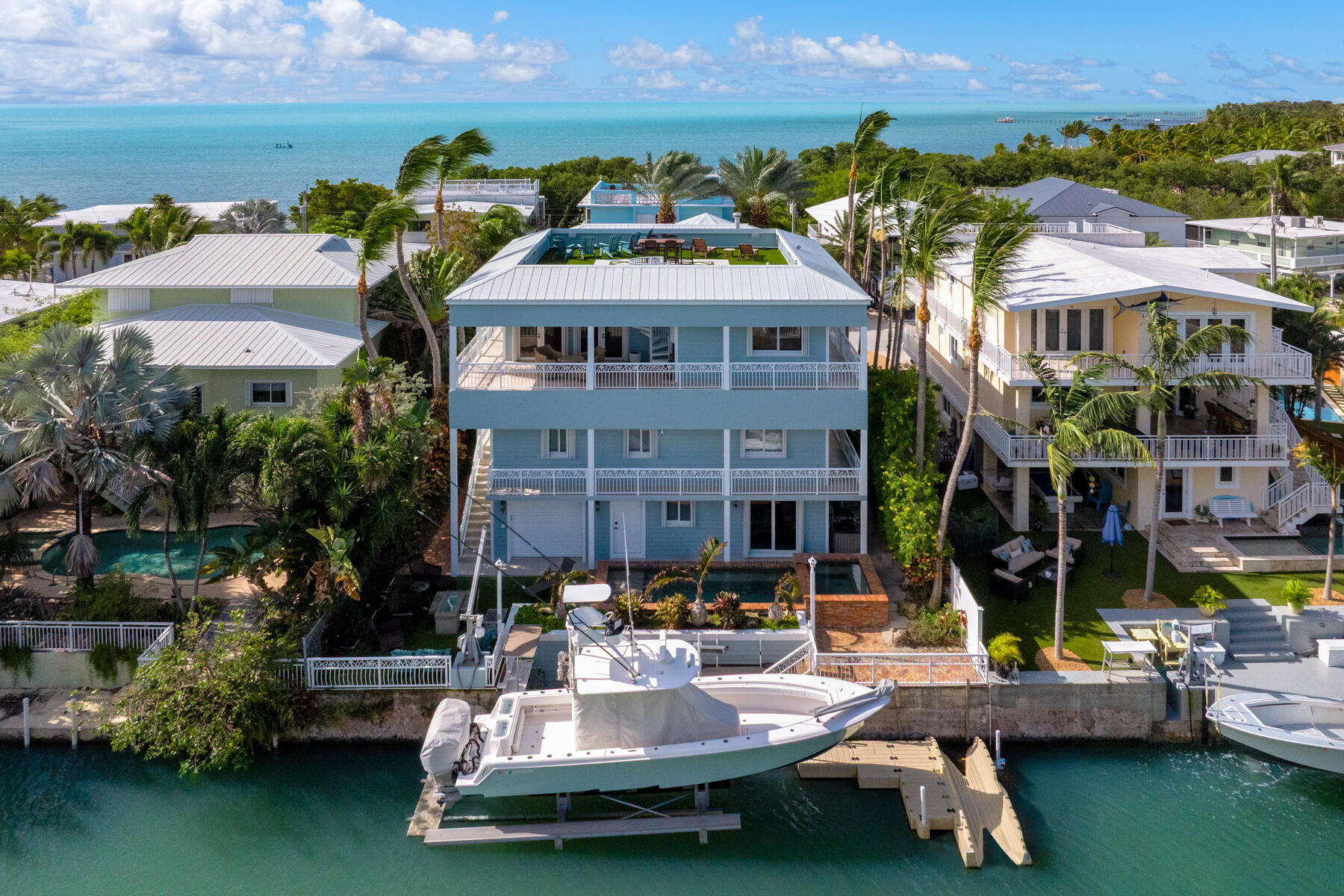 141 Canal Street Tavernier, FL 33070 - Photo 43 of 90 an aerial view of a house with swimming pool and lake view