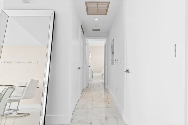 a living room with furniture and a glass door shower