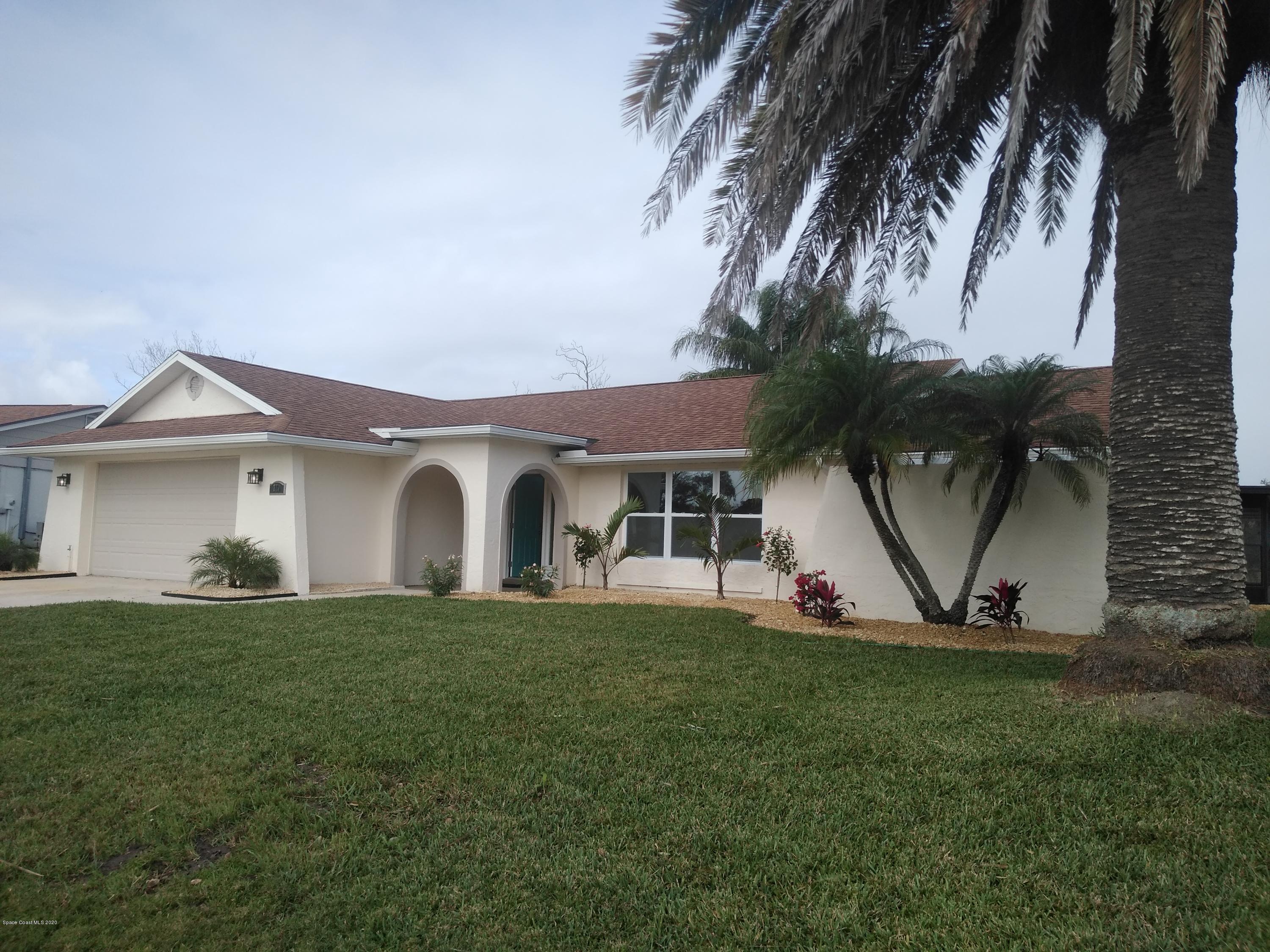 770 Montclair Road Northeast, Unit 1 Palm Bay, FL 32905 - Photo 1 of 23 a front view of a house with a yard