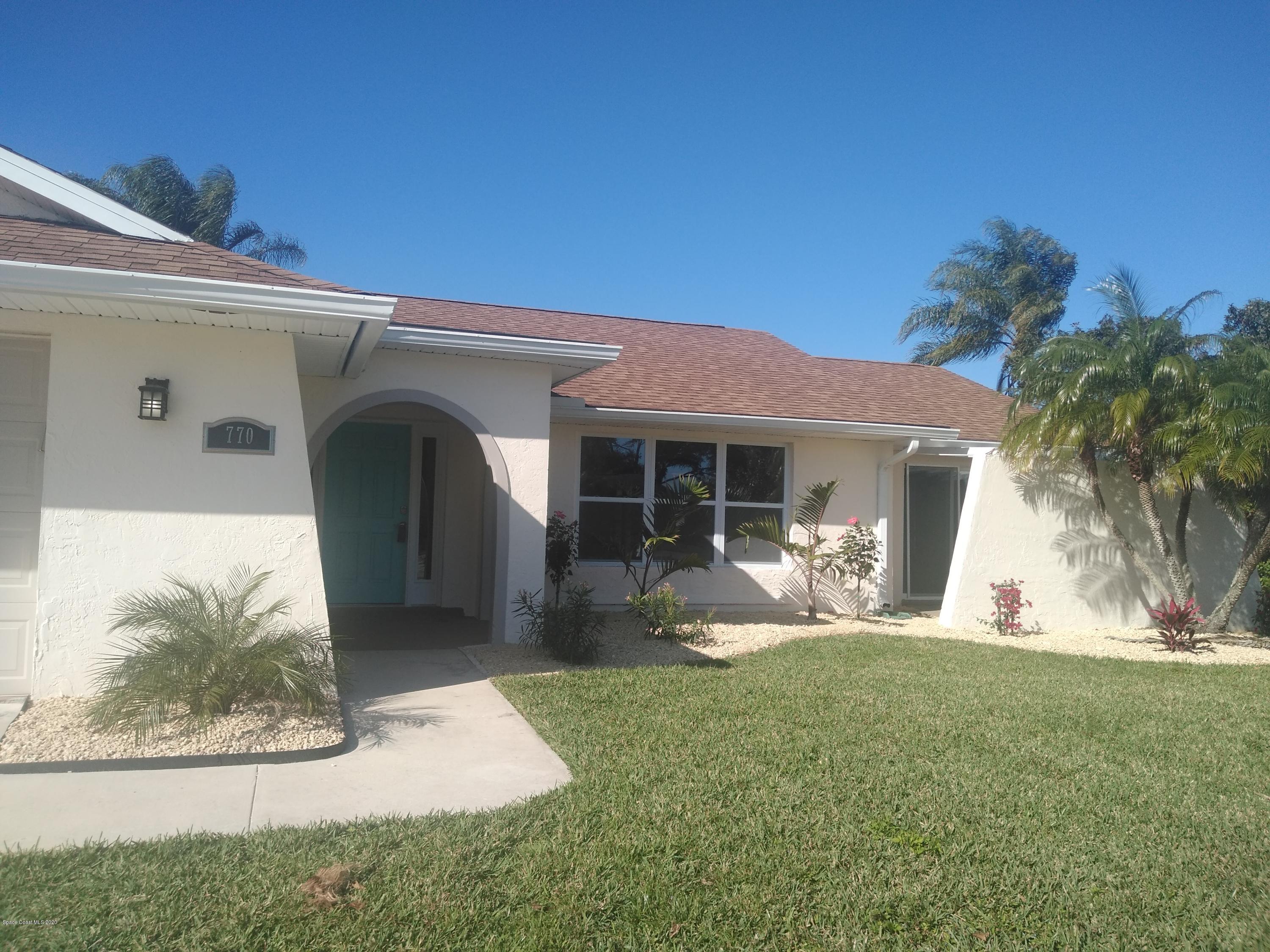770 Montclair Road Northeast, Unit 1 Palm Bay, FL 32905 - Photo 2 of 23 a view of a house with backyard sitting area and porch