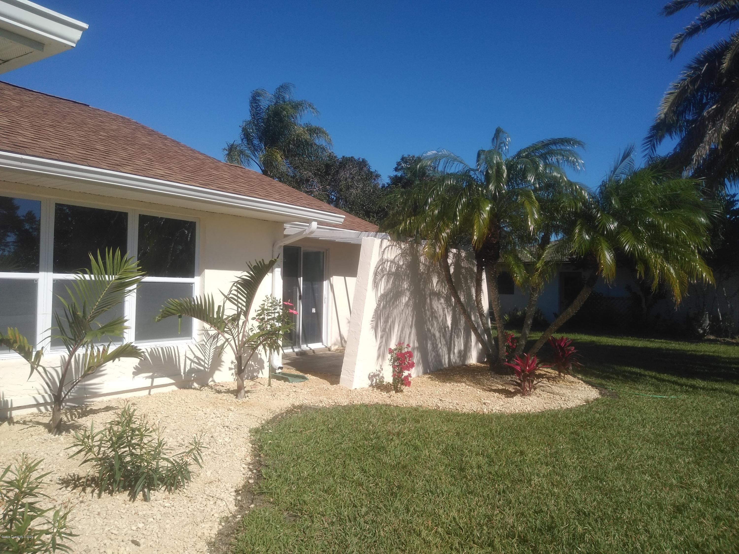 770 Montclair Road Northeast, Unit 1 Palm Bay, FL 32905 - Photo 5 of 23 a front view of a house with a yard