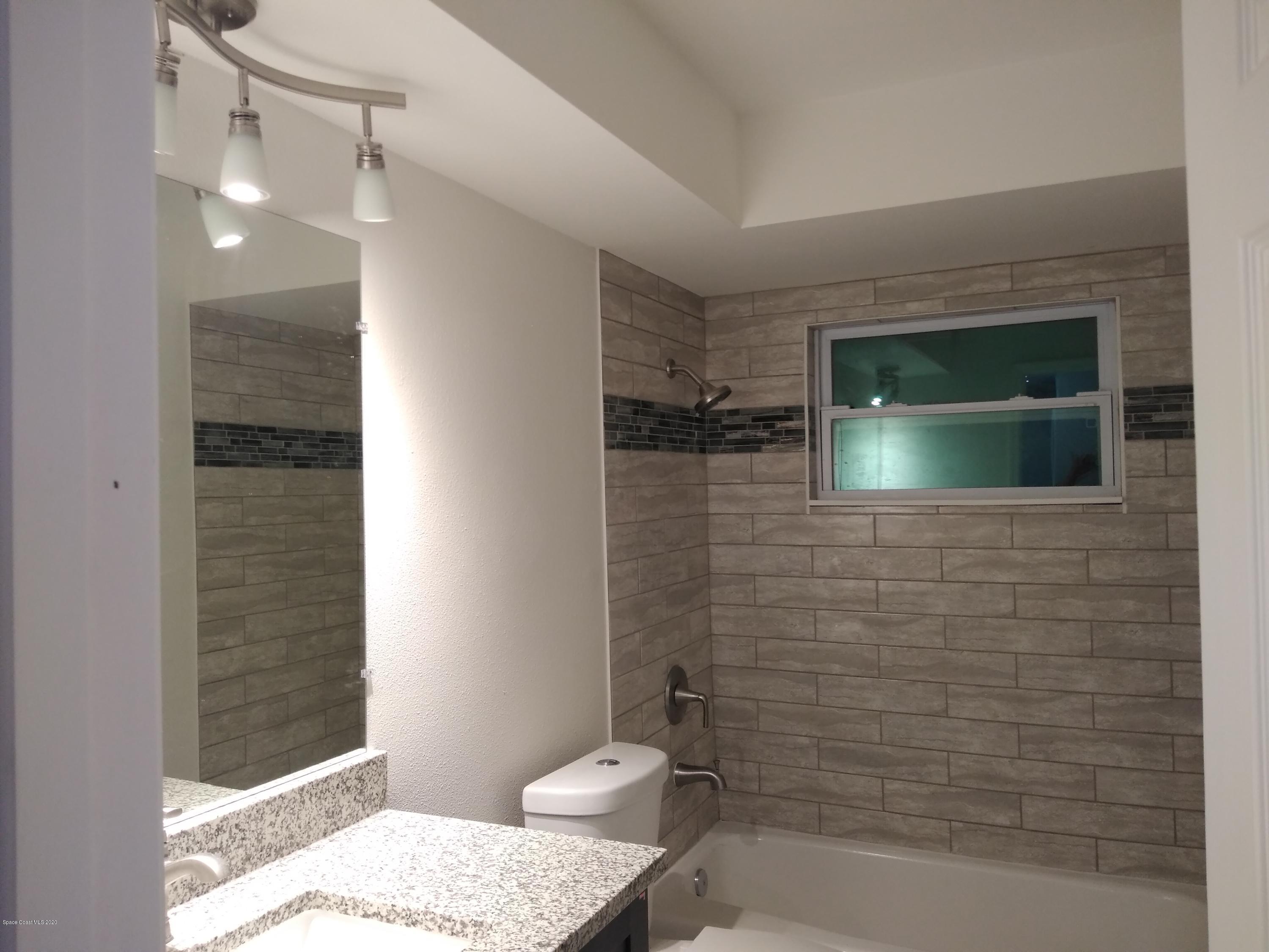 770 Montclair Road Northeast, Unit 1 Palm Bay, FL 32905 - Photo 10 of 23 a bathroom with a sink and a shower