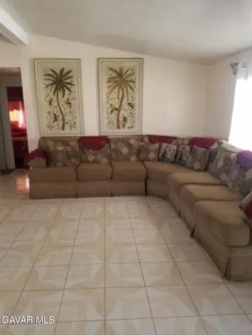 a living room with couches and a black couches with rug