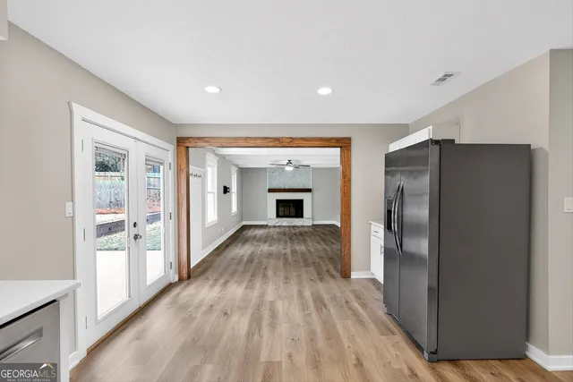 a view of empty room with wooden floor and fireplace