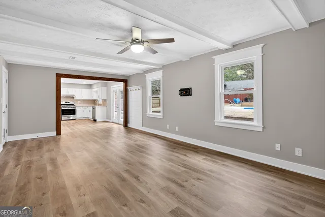 a view of a hallway with wooden floor
