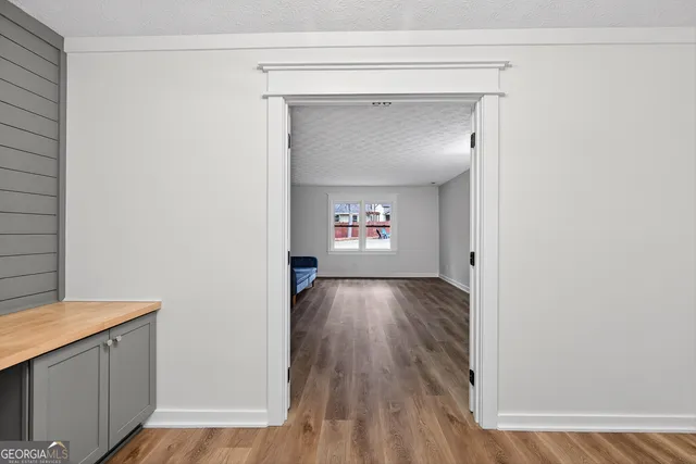 a view of a livingroom with wooden floor and entryway