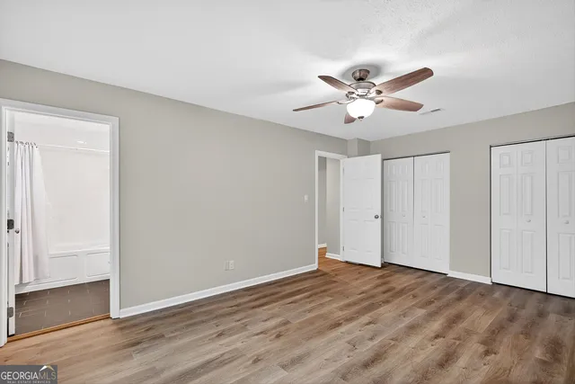 a view of a street with car parked on the road