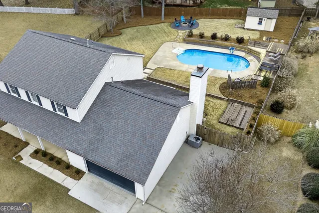 an aerial view of a house with swimming pool