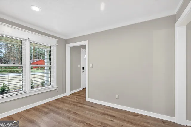 a spacious bathroom with a granite countertop sink and a mirror