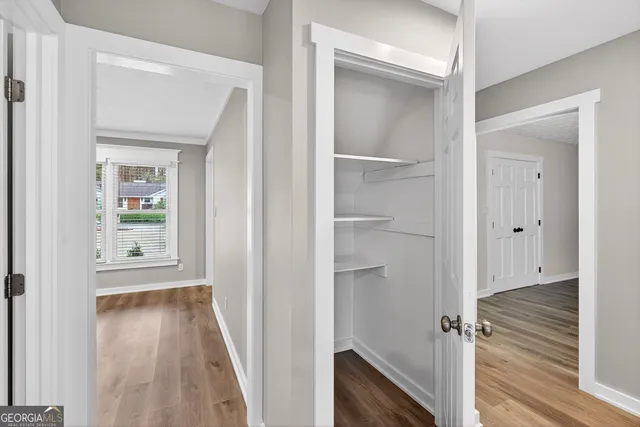 a kitchen with stainless steel appliances granite countertop a stove a sink and white cabinets