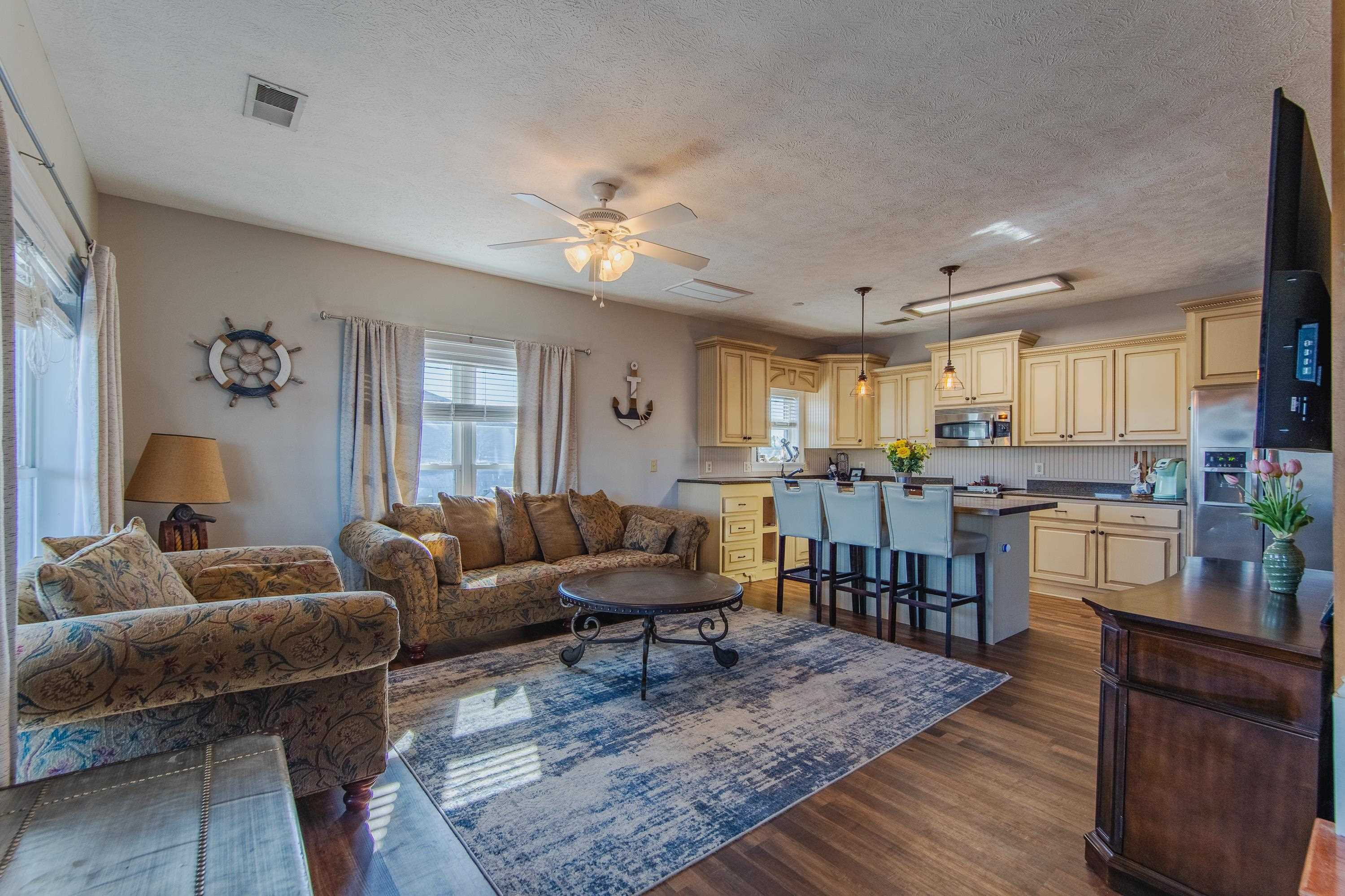 1111 Leaning Trees Lane Adamsville, TN 38310 - Photo 7 of 36 Open-concept living area with wood-finish flooring, a ceiling fan, and recessed lighting