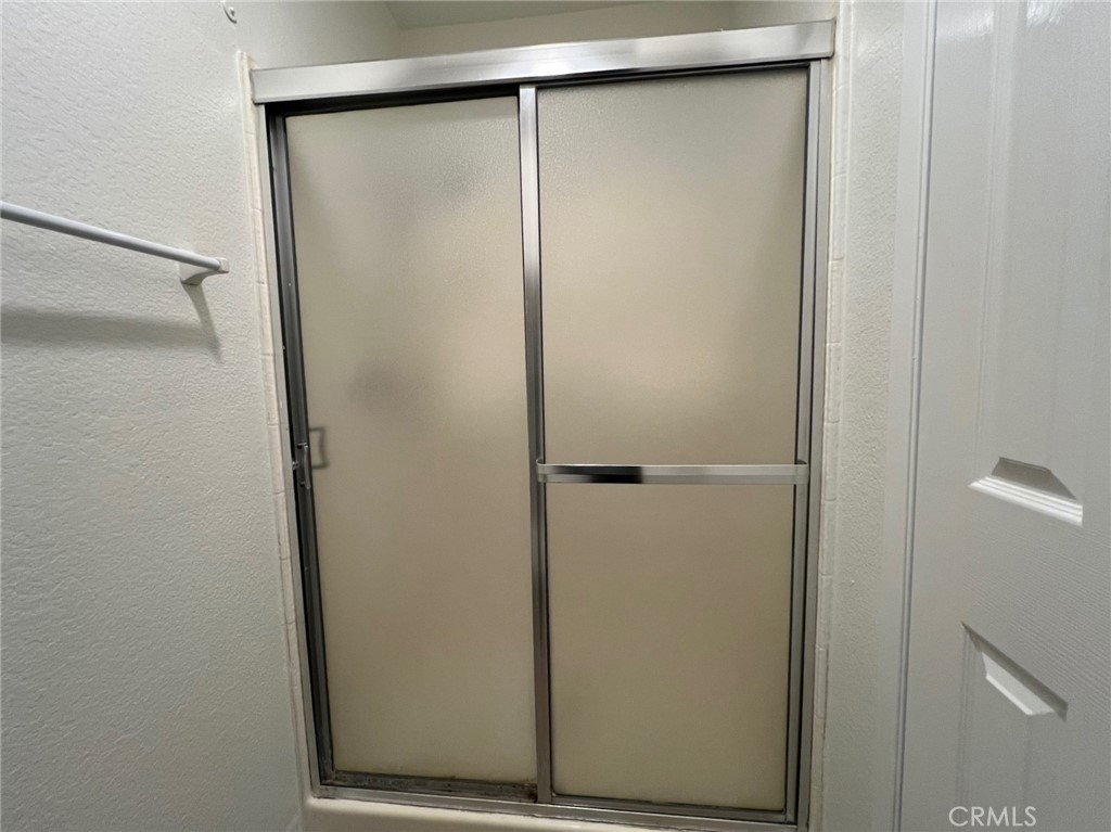 16 Key West Laguna Niguel, CA 92677 - Photo 16 of 23 a bathroom with a glass shower door