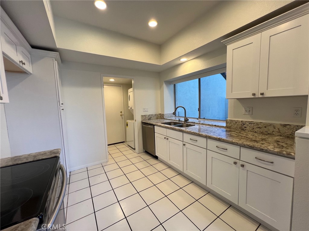 16 Key West Laguna Niguel, CA 92677 - Photo 2 of 23 a kitchen with a sink and cabinets