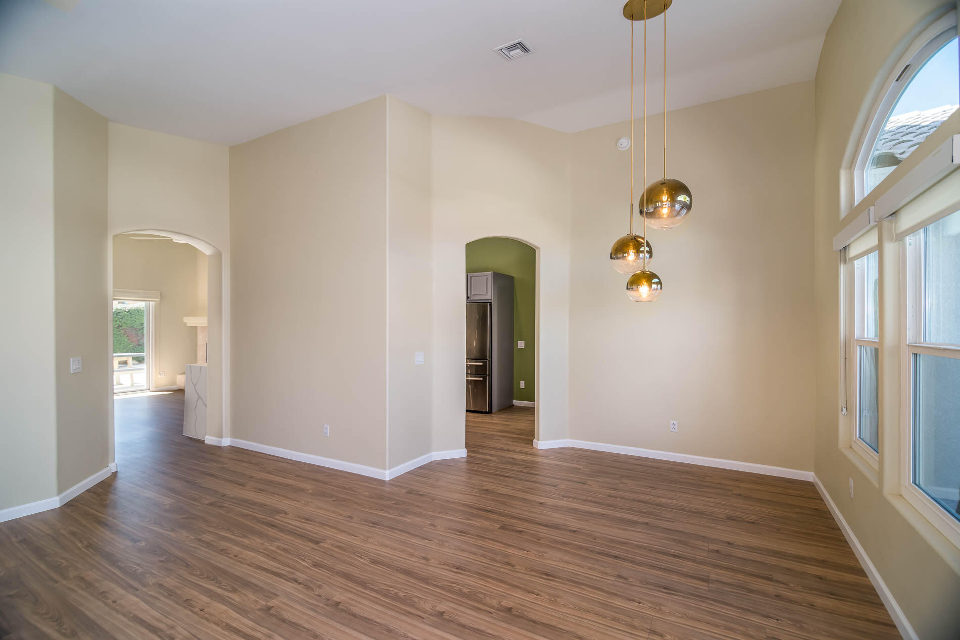 67685 Garbino Road Cathedral City, CA 92234 - Photo 14 of 45 a view of an empty room with wooden floor and a window