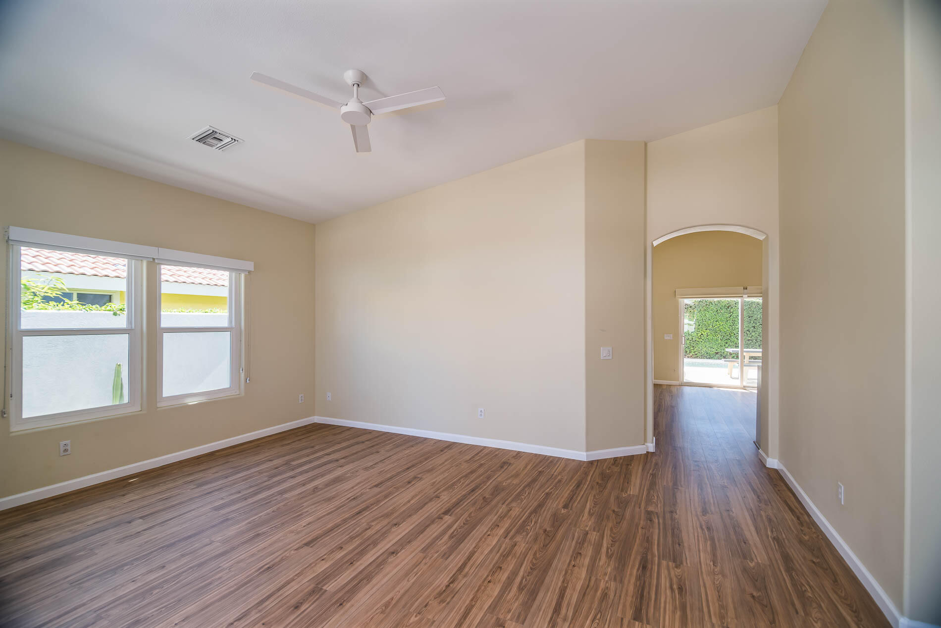 67685 Garbino Road Cathedral City, CA 92234 - Photo 17 of 45 wooden floor in an empty room with a window