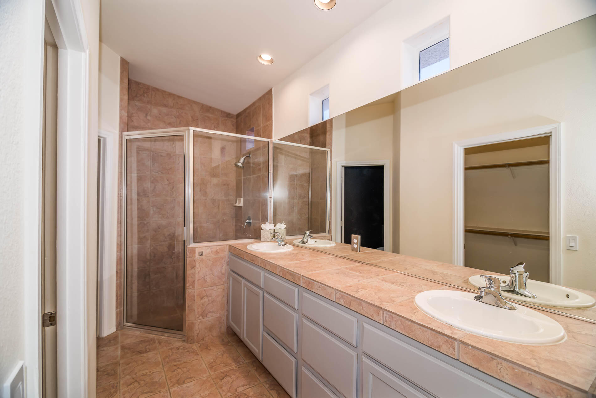 67685 Garbino Road Cathedral City, CA 92234 - Photo 21 of 45 a bathroom with a double vanity sink and a mirror