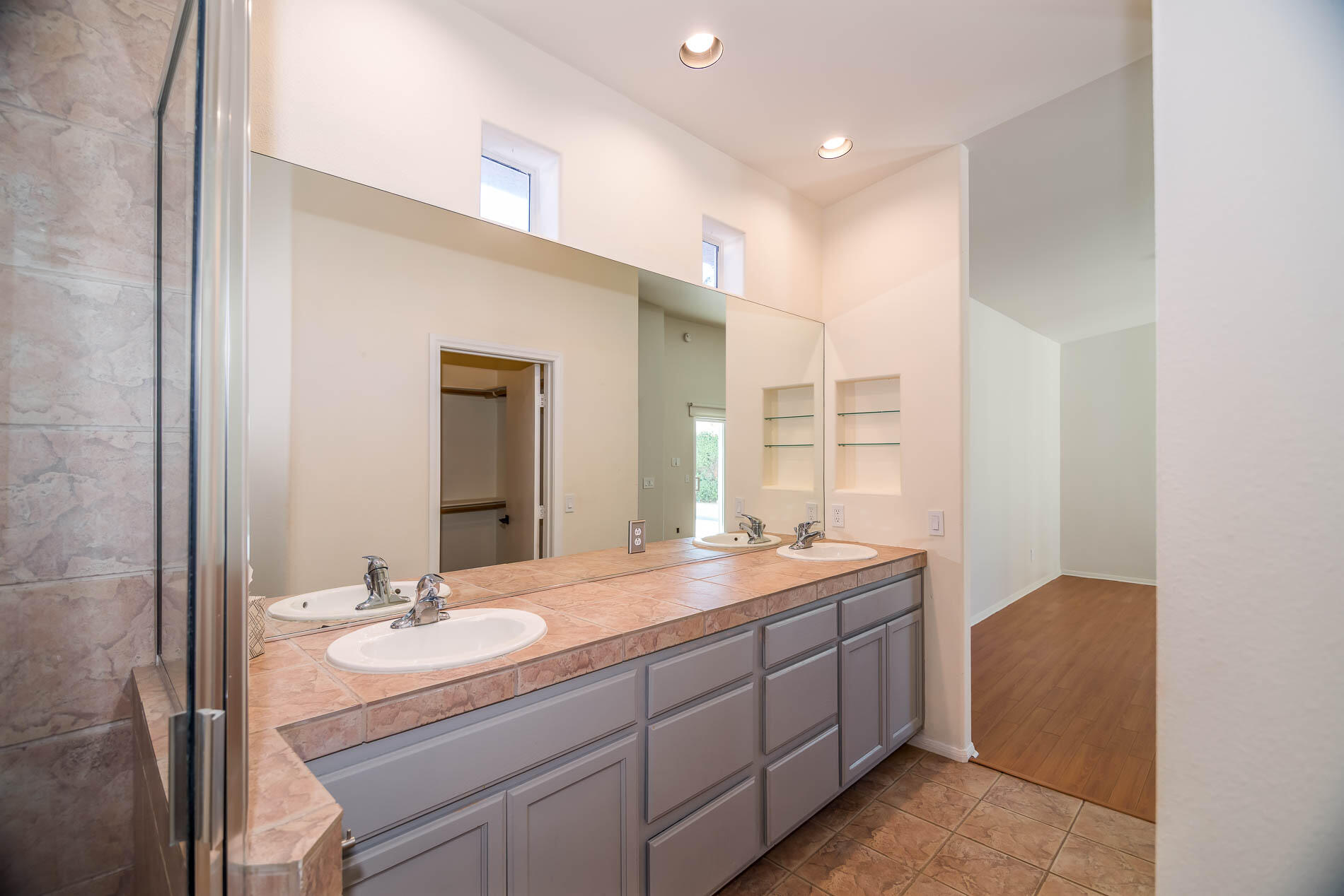 67685 Garbino Road Cathedral City, CA 92234 - Photo 22 of 45 a bathroom with a sink double vanity granite tub shower and a mirror
