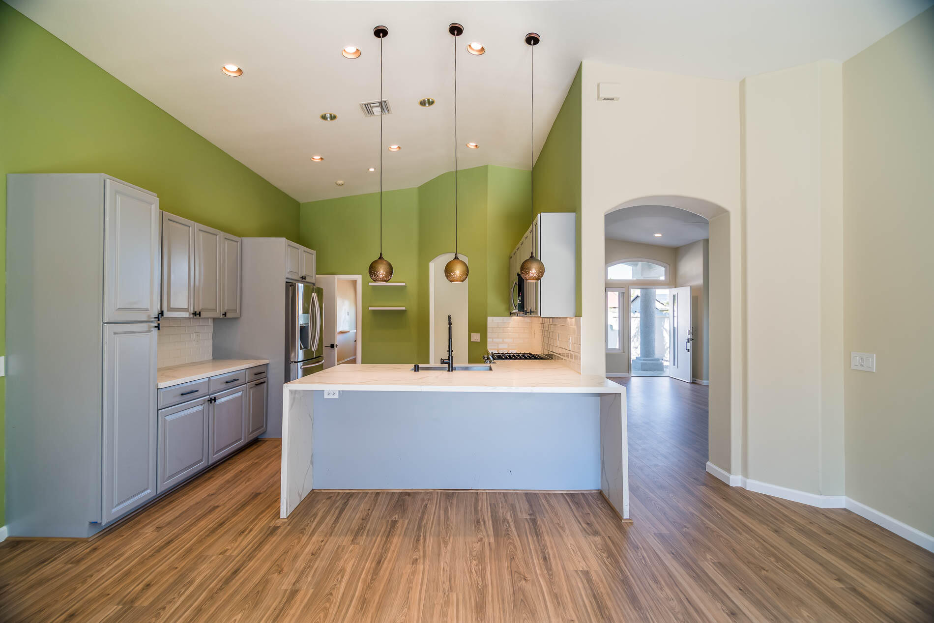 67685 Garbino Road Cathedral City, CA 92234 - Photo 27 of 45 a large kitchen with a wooden floor and natural light