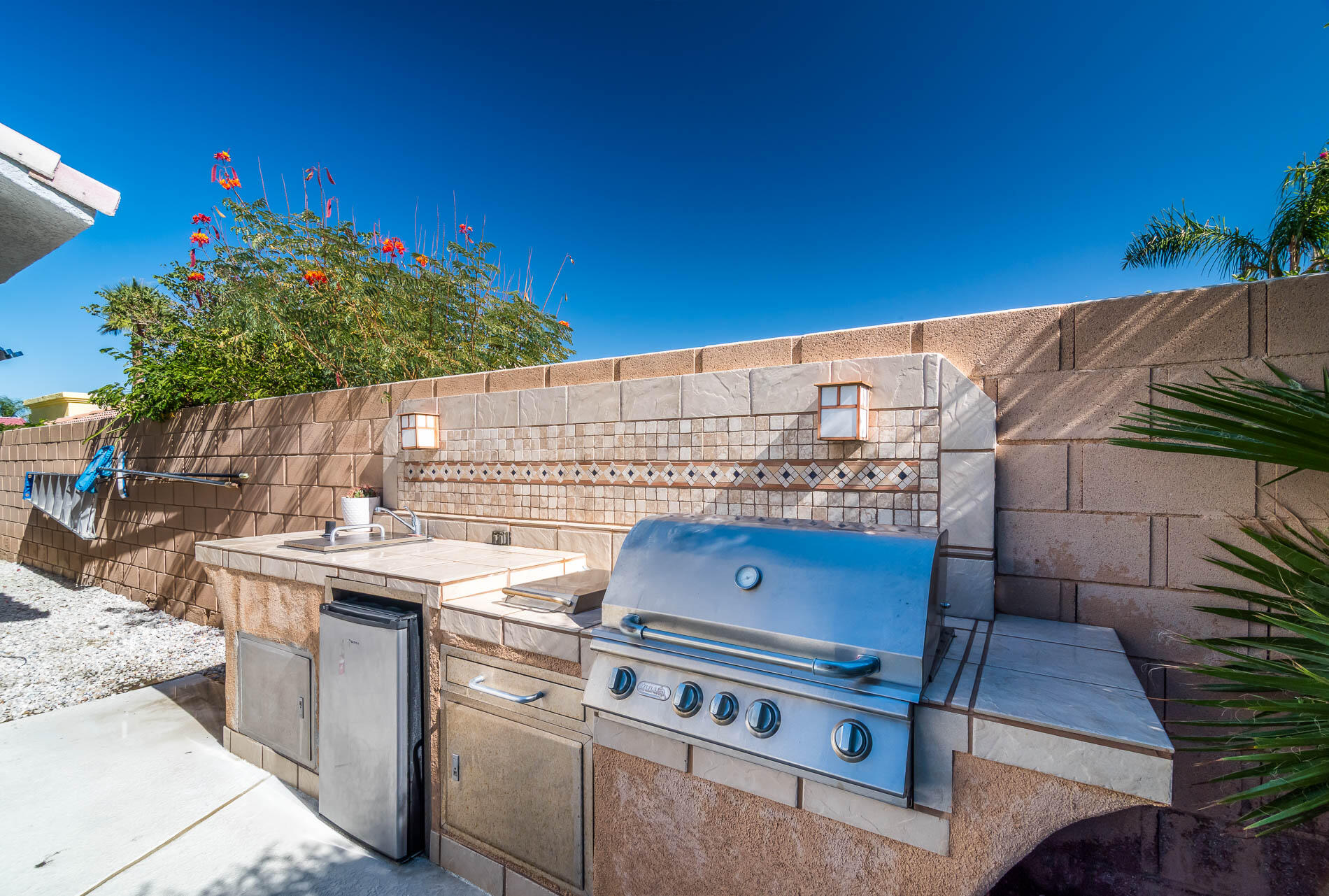 67685 Garbino Road Cathedral City, CA 92234 - Photo 41 of 45 a view of a patio with table and chairs and potted plants