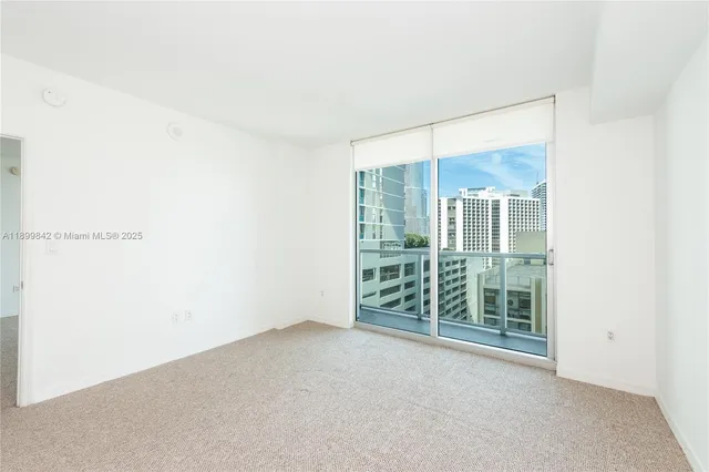 a view of an empty room with glass door