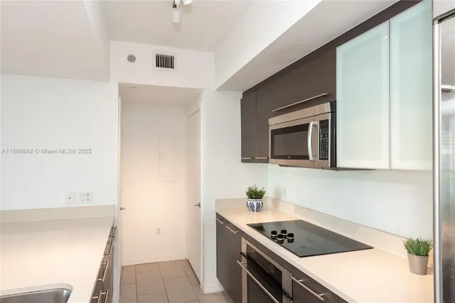 a kitchen with a sink and a stove top oven