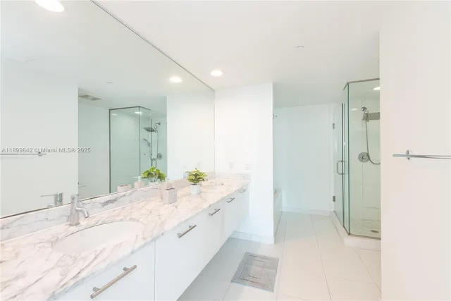 a spacious bathroom with a granite countertop sink mirror and double
