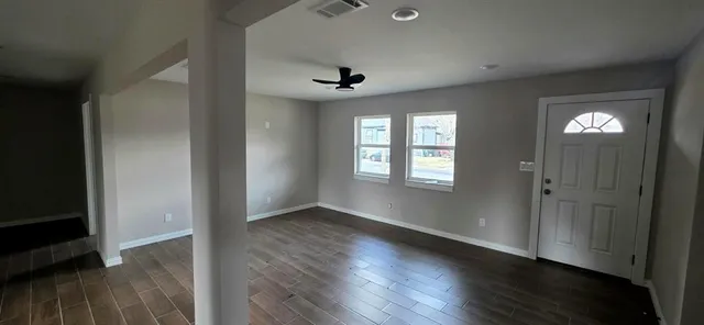 wooden floor in an empty room with a window