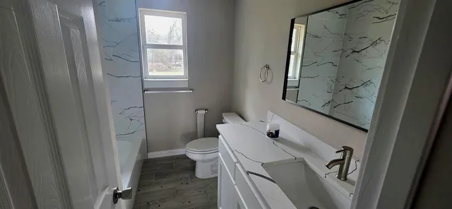 a bathroom with a toilet and a shower