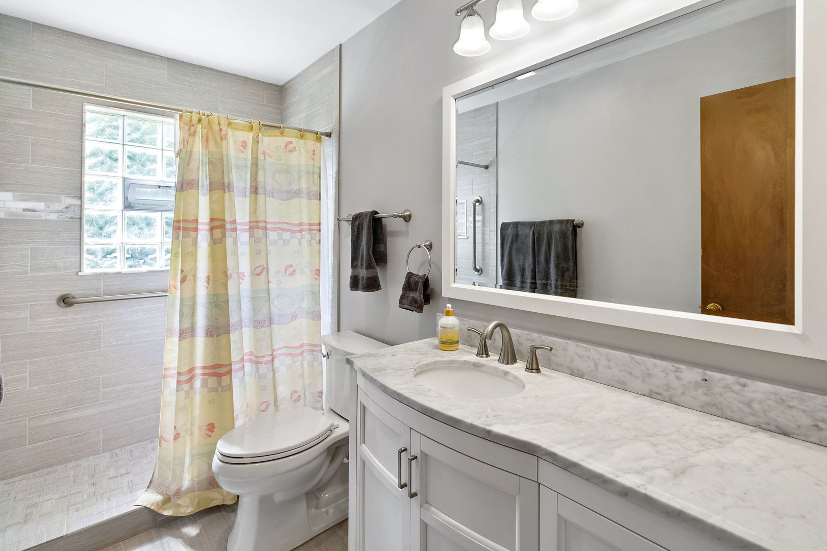 586 Raupp Boulevard Buffalo Grove, IL 60089 - Photo 9 of 26 a bathroom with a granite countertop sink toilet and shower