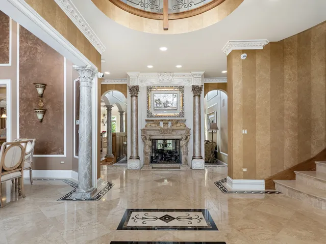 a dining room with furniture a chandelier and wooden floor