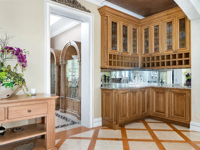 a kitchen with kitchen island a counter top space a sink stainless steel appliances and cabinets