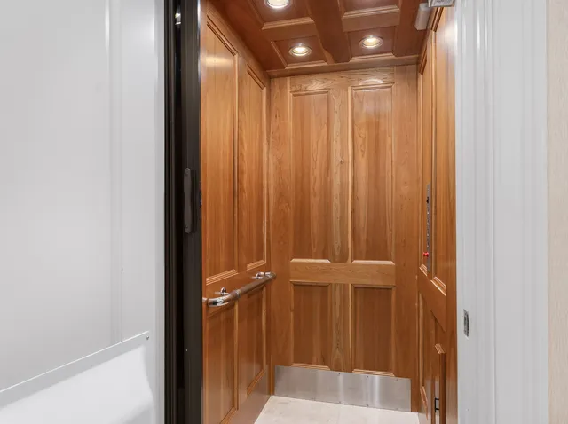 a living room with furniture a fireplace and a chandelier