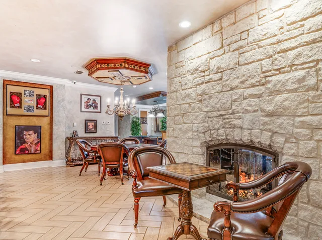 a room with lots of wooden furniture and a large window