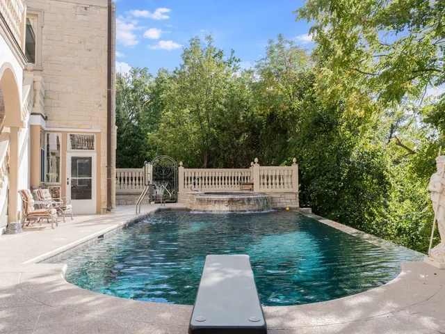 swimming pool view with a garden space