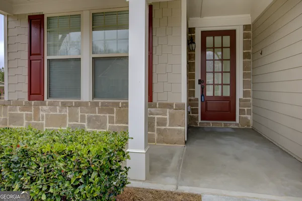 front view of a brick house with a yard