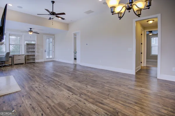 wooden floor in kitchen and dining room with furniture and chandelier