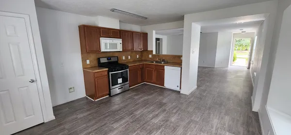 a kitchen with wooden floors and a sink