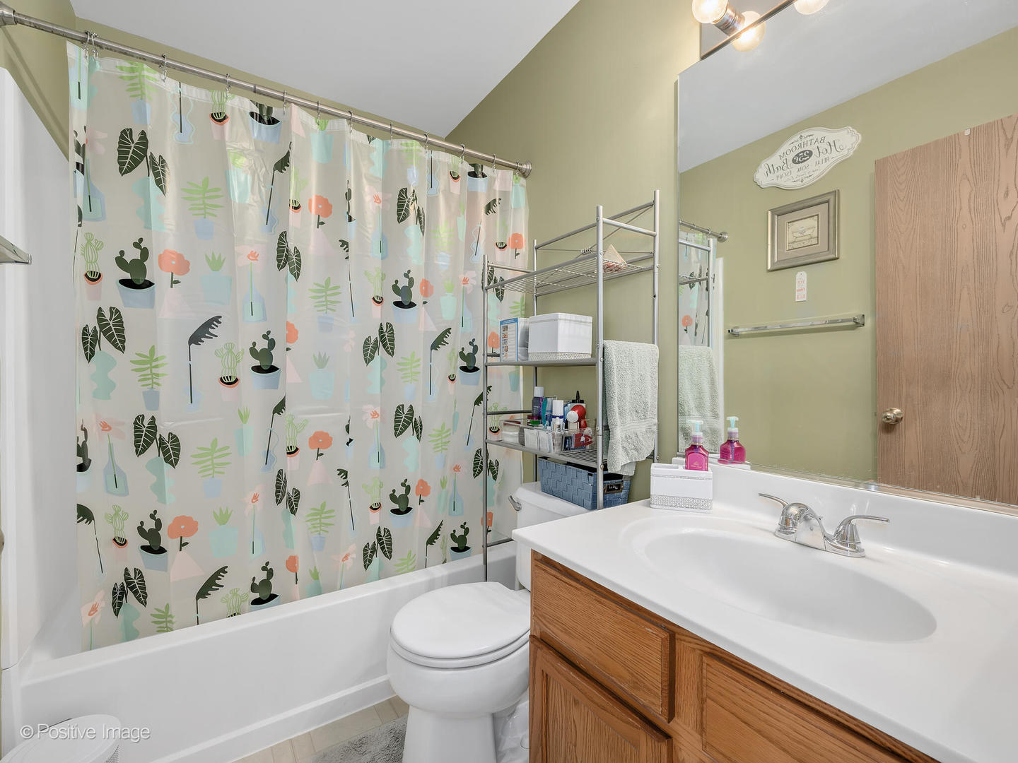 2538 Carrolwood Road Naperville, IL 60540 - Photo 13 of 16 a bathroom with a granite countertop sink a toilet a mirror a bathtub and shower curtain