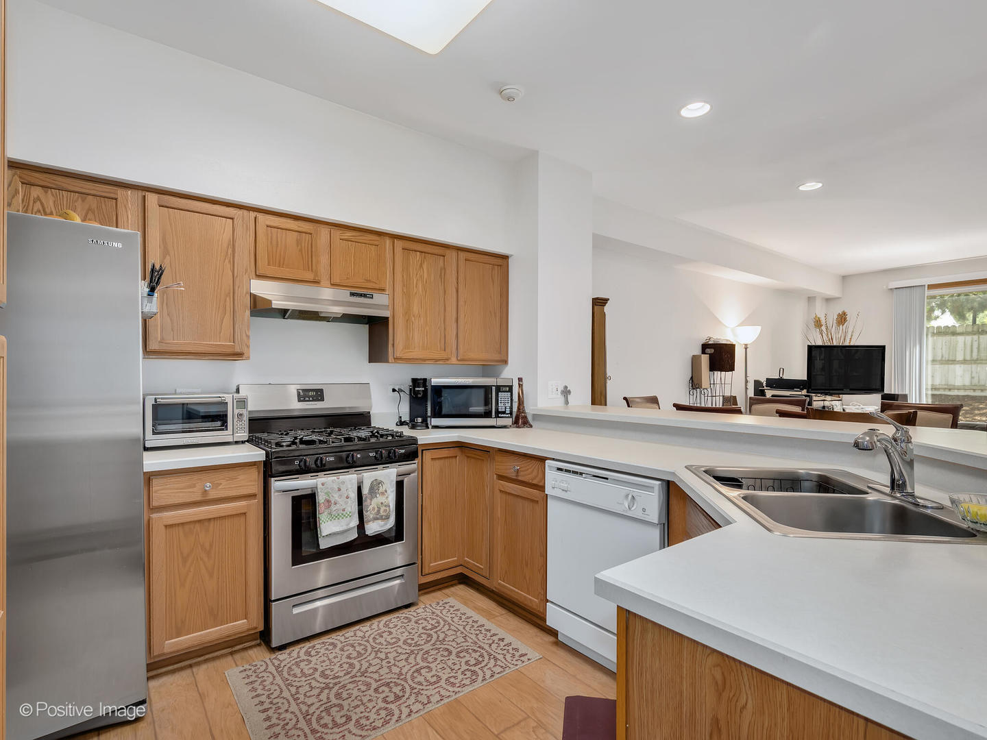 2538 Carrolwood Road Naperville, IL 60540 - Photo 8 of 16 a kitchen with a sink stove top oven and cabinets