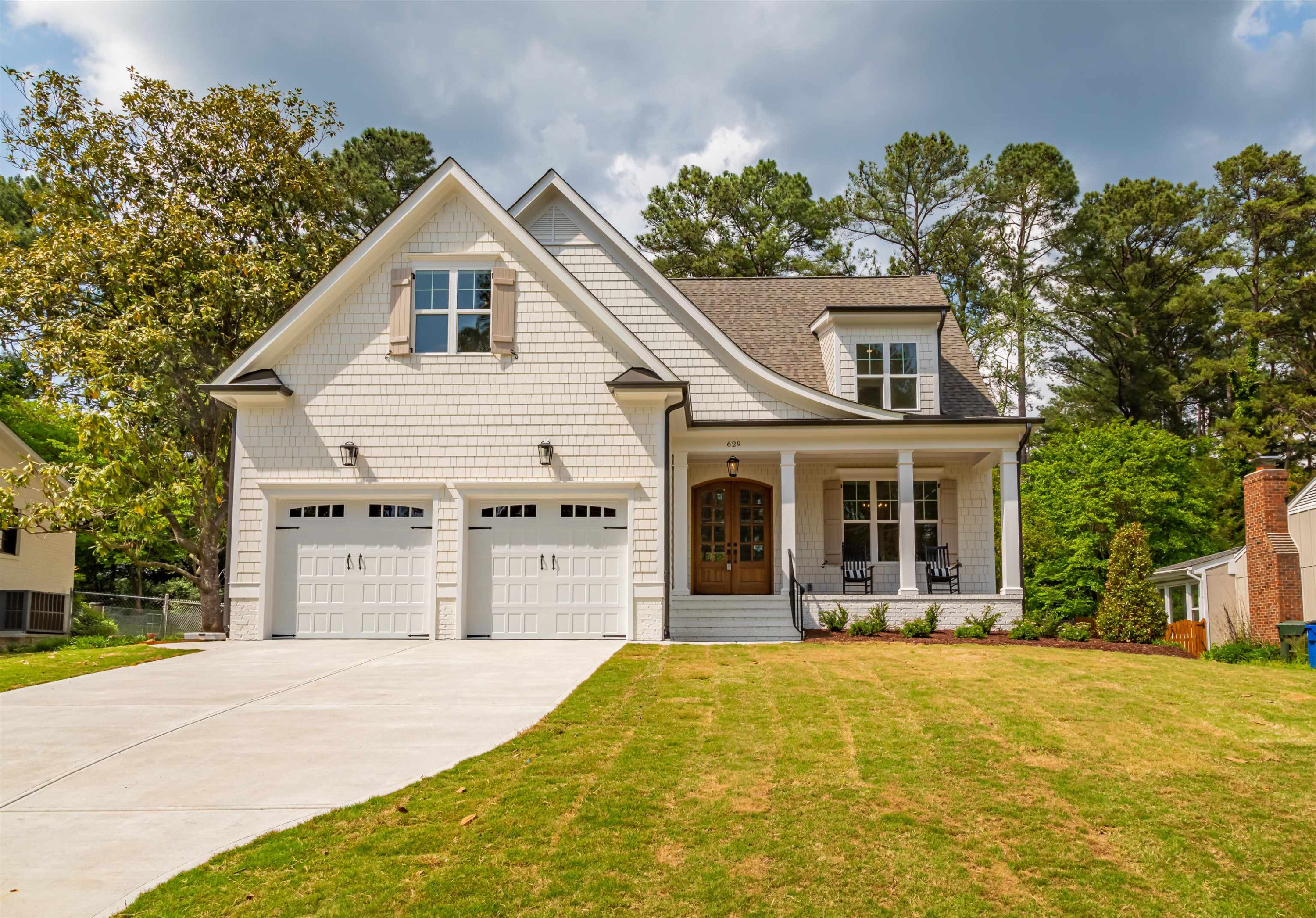 1220 Dixie Trail Raleigh, NC 27607 - Photo 1 of 40 a front view of a house with a yard and garage