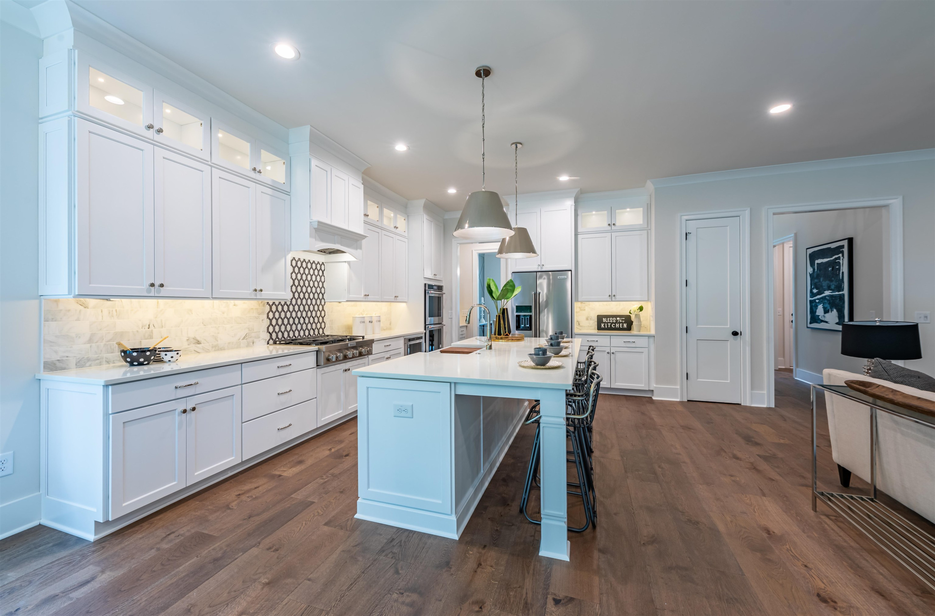 1220 Dixie Trail Raleigh, NC 27607 - Photo 12 of 40 a large kitchen with cabinets wooden floor white stainless steel appliances and view living room
